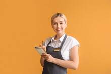 Young Female Waiter On Color Background