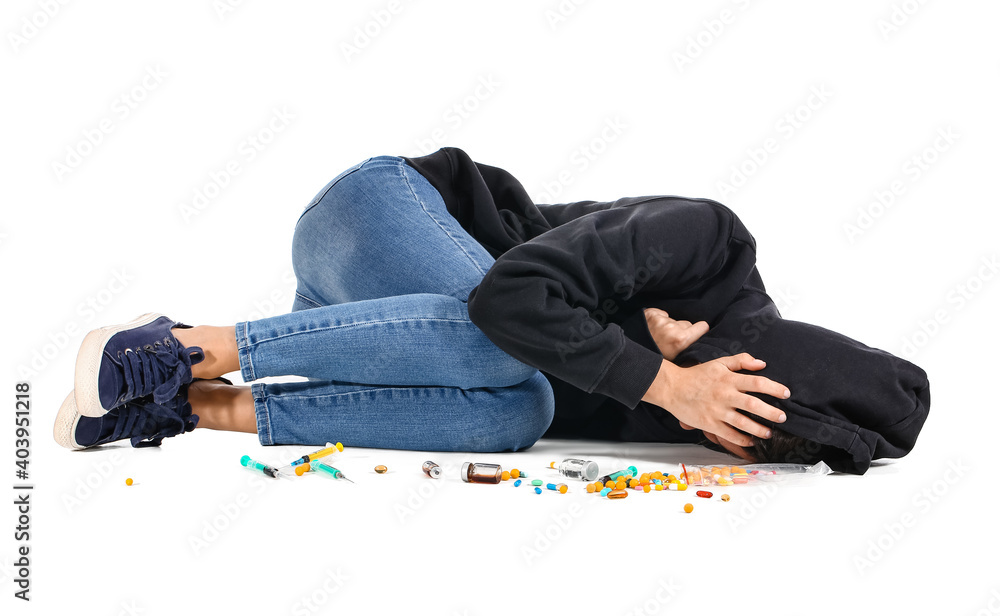 Female junkie with drugs on white background