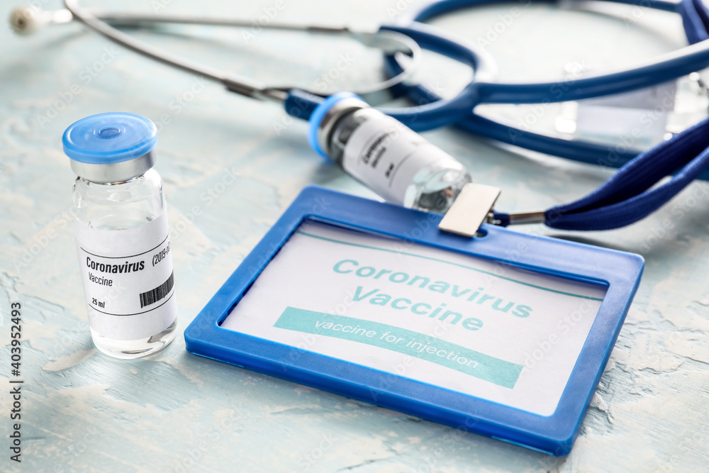 Vaccine for immunization against COVID-19 and stethoscope on table