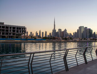 Wall Mural - Dubai, UAE - 01.08.2021 View of the Dubai city skyline at Dubai Water Canal. Business Bay district. Tallest building in the world Burj Khalifa can be seen in the picture. Outdoors