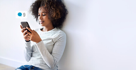 Wall Mural - Happy black woman using social media on her smartphone