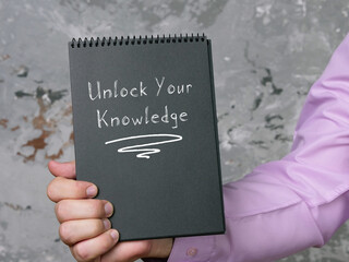 Motivational concept about Unlock Your Knowledge with sign on the piece of paper.