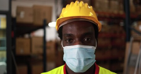 Sticker - African worker man inside delivery box warehouse while wearing protective mask for coronavirus outbreak