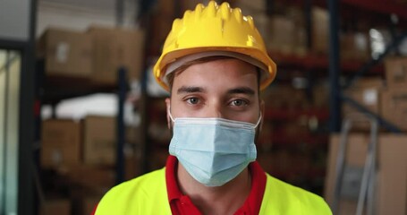 Wall Mural - Worker man inside delivery boxes warehouse while wearing protective mask during coronavirus outbreak