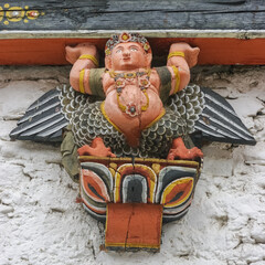 Colorful traditional painted kinnara - half bird half human - wood sculpture used as corbel in Tashichho dzong in Thimphu, Bhutan