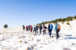 group of people hiking sport on snowy mountain together happy and enjoying snow