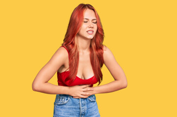 Canvas Print - Young redhead woman wearing casual clothes with hand on stomach because nausea, painful disease feeling unwell. ache concept.