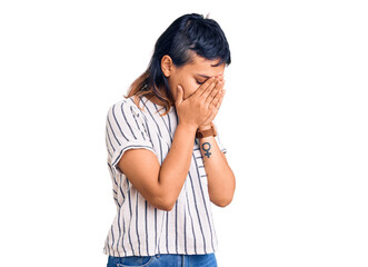 Wall Mural - Young woman wearing casual clothes with sad expression covering face with hands while crying. depression concept.