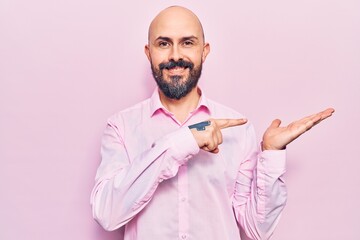 Sticker - Young handsome man wearing business clothes amazed and smiling to the camera while presenting with hand and pointing with finger.