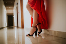 Closeup Shot Of A Woman On A Red Gown Wearing A Beautiful Ankle Strap High Heels Sandal