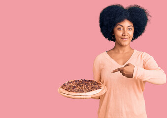 Canvas Print - Young african american girl holding italian pizza smiling happy pointing with hand and finger