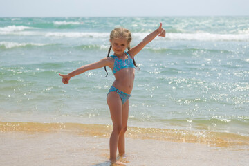 Child in on the ocean. Little girl on the beach.