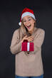© MrsLePew - beautiful woman holding a Christmas and New Year gift. Christmas girl in santa hat with red box..