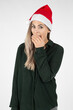 © MrsLePew - Portrait of beautiful young woman wearing a santa hat, whispering with hand in front mouth white background