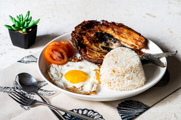 Daingsilog- is a famous Filipino meal can be eaten as breakfast lunch or even dinner and is composed of boneless fried milkfish, fried egg, and garlic rice.