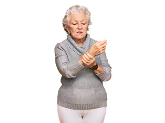 Senior grey-haired woman wearing casual winter sweater suffering pain on hands and fingers, arthritis inflammation