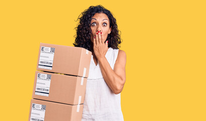 Sticker - Middle age beautiful woman holding delivery package covering mouth with hand, shocked and afraid for mistake. surprised expression