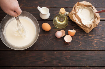 dough  and products for its preparation on  dark wooden backgrou