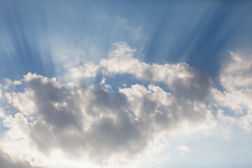 White cloud and sun rays in sky