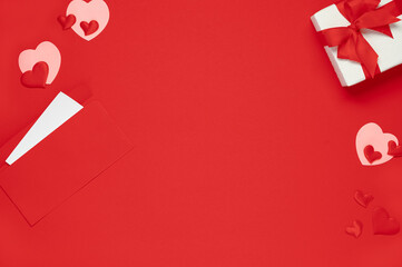 Valentine day template. Top view of gift box and hearts of red background. Flat lay postcard