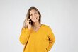 © MrsLePew - Portrait of young happy blond woman talking on mobile phone against white background