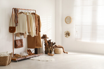 Poster - Modern dressing room interior with rack of stylish shoes and women's clothes