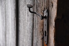 Close-up Of Rusty Handle On Wooden Door