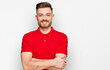 © Krakenimages.com - Young redhead man wearing casual clothes happy face smiling with crossed arms looking at the camera. positive person.