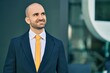 © Krakenimages.com - Young hispanic bald businessman smiling happy standing at the city.