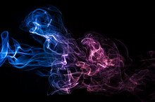 Neon Pink, Purple And Blue Smoke In The On A Dark Isolated Background. Background From The Smoke Of Vape. Web And App Concept.
