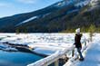 Young woman admiring the winter landscape at Emerald Lake, in Yoho National park, Canada