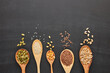 Different kinds of nuts and seeds on black slate background. Top view with copy space. Healthy food. Vegetarian nutrition