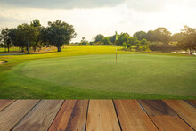Wooden Floor And Golf Course Background. Fresh Spring Green Golf Course With Wood Floor. Beauty Natural Background, Empty Wooden Deck Table With Green Background.