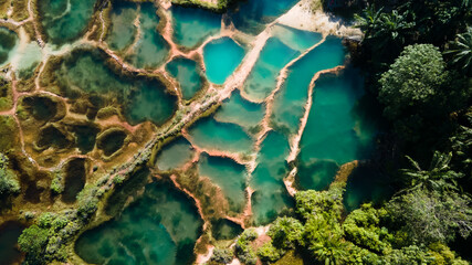 Aerial top down view of beautiful nature abstract crystal clear emarald pool during sunrise