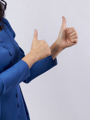 A girl on a white background shows her hands like, class.