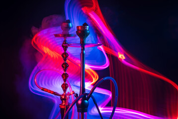 Wall Mural - two hookah bowls with shisha charcoals with smoky smoke with blue red neon lights