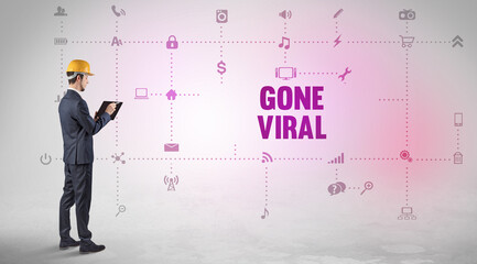 Engineer working on a new social media platform with GONE VIRAL inscription concept