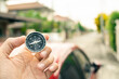 Man hand holding compass on city and car blurred background Using wallpaper or background travel or navigator image.