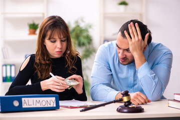 Wall Mural - Young couple divorcing in alimony concept