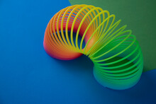 Plastic  Magic Spring Rainbow Toy In Colourful Background With Copy Space For Your Own Text, Photography
