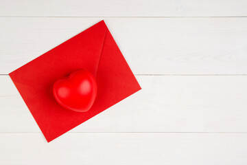 Wall Mural - Valentine day with heart shape on red envelope on wooden desk, postcard or greeting card for congratulating, message and celebration, love and romance, top view, flat lay, holiday concept.