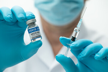 COVID-19 vaccine in the hands of medical staff