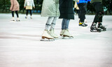People ice skating on the ice rink in winter.