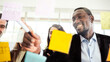 © artitwpd - Close-up of smiling African businessman brainstorm meeting with colleagues by using colorful sticky paper note on glass wall for finding new ideas. Using agile methodology and do business.