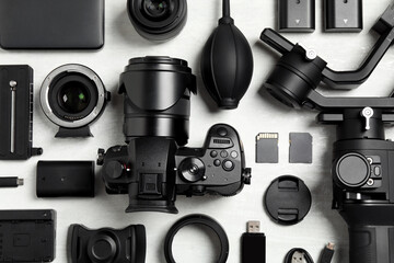 Wall Mural - flat lay composition with camera and video production equipment on light background