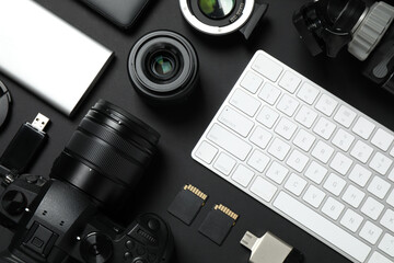 Wall Mural - camera, video production equipment and computer keyboard on black background, flat lay