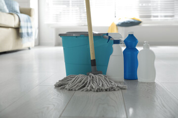 Wall Mural - Bucket, mop and different cleaning products on floor indoors