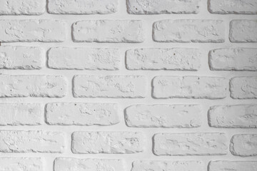 Brick white wall of plaster with your own hands in the interior.