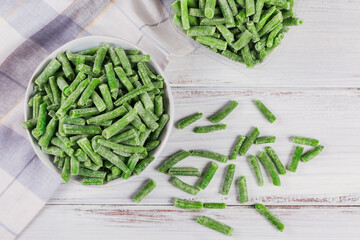 Cut green beans in a bowl and in a plastic container. Concept of homemade preparations for fast cooking. Healthy vegetarian food concept