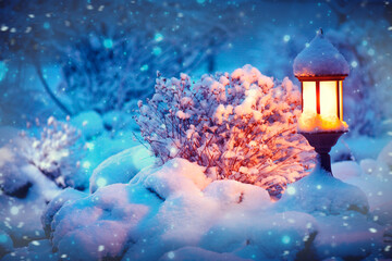 Poster - Winter scene. Xmas Decoration with a lantern on snow in a winter garden. Christmas Background. Lamp at night. Garden design.